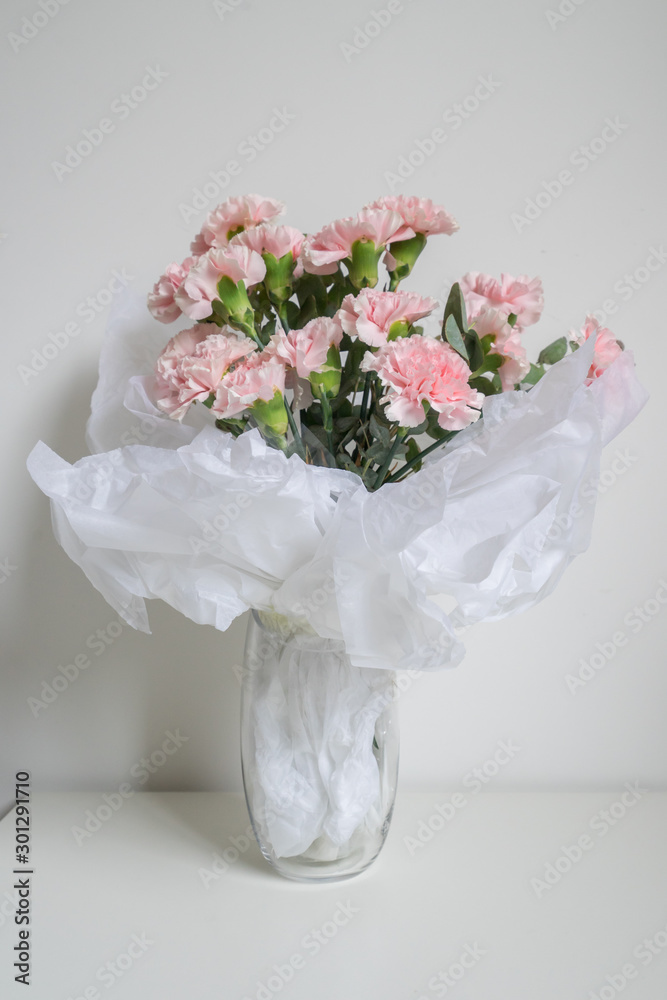 Carnations flower in the glass vase.