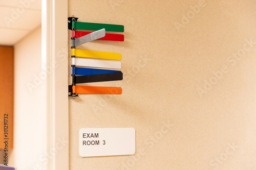 Colored Signals on door of patient exam room, in medical clinic photo