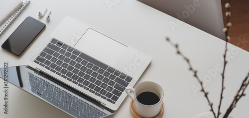 Cropped shot of comfortable workspace with laptop computer and office supplies