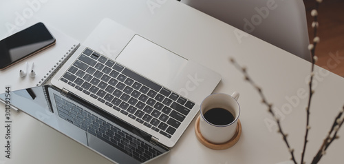 Cropped shot of comfortable workspace with laptop computer and office supplies
