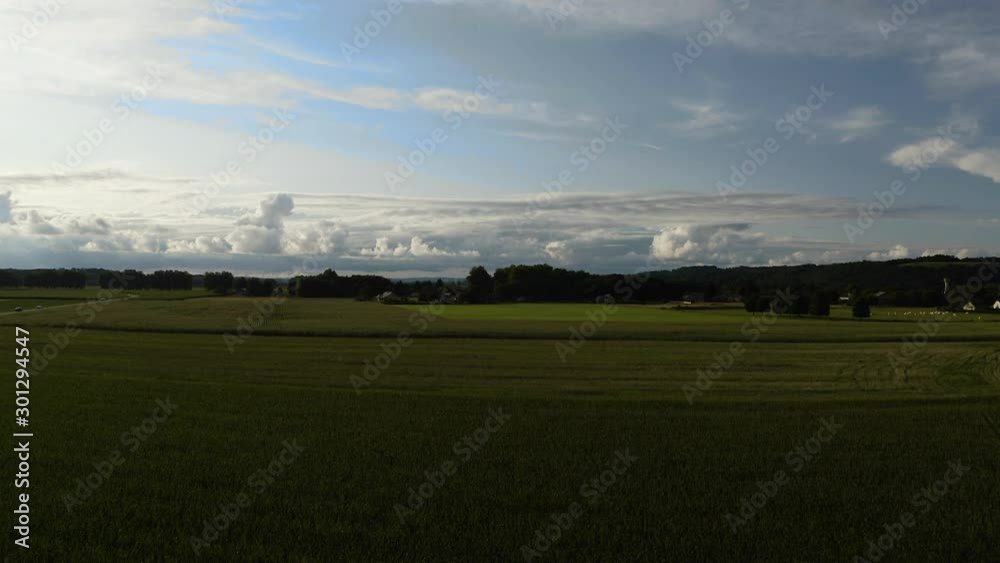 Aerial Drone shot on french field for agriculture with green vegetation in Basque country, France. Cloudy blue sky, French countryside forest in 4K UHD, end of afternoon. Aerial Drone shot on french field for agriculture with green vegetation in Basque country, France. Cloudy blue sky, French countryside forest in 4K UHD, end of afternoon.