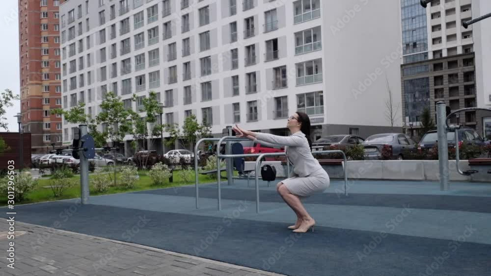 custom made wallpaper toronto digitalA woman in a business suit and heels does a sit-up outside. Business woman in glasses doing exercises on the buttocks during a lunch break.
