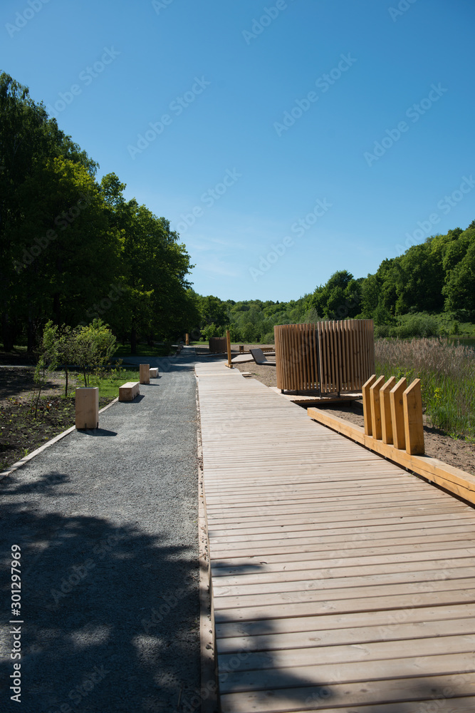 Wooden footpaths in the park on a summer day.