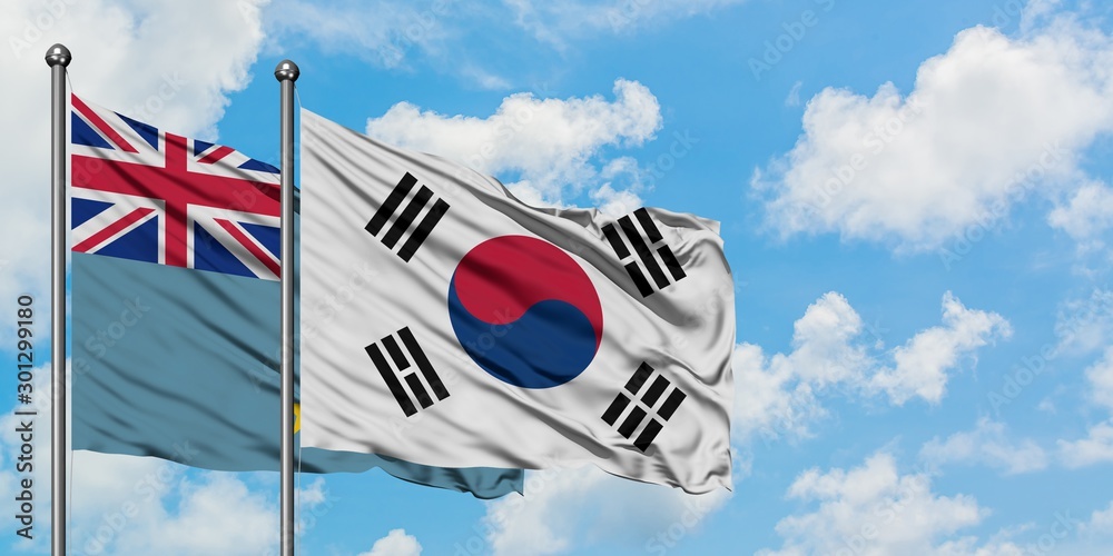 Obraz premium Tuvalu and South Korea flag waving in the wind against white cloudy blue sky together. Diplomacy concept, international relations.