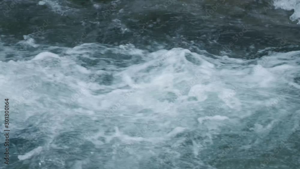 Water churns in a river in slow motion Water churns in a river in slow motion
