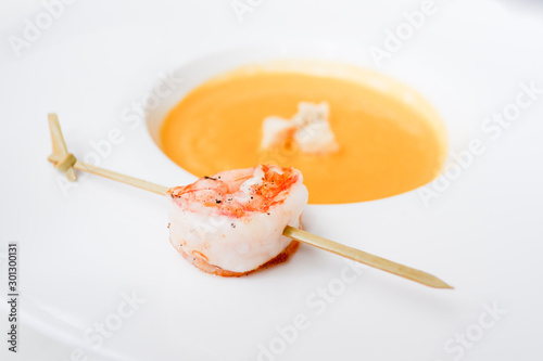 Creamy lobster soup on white plate