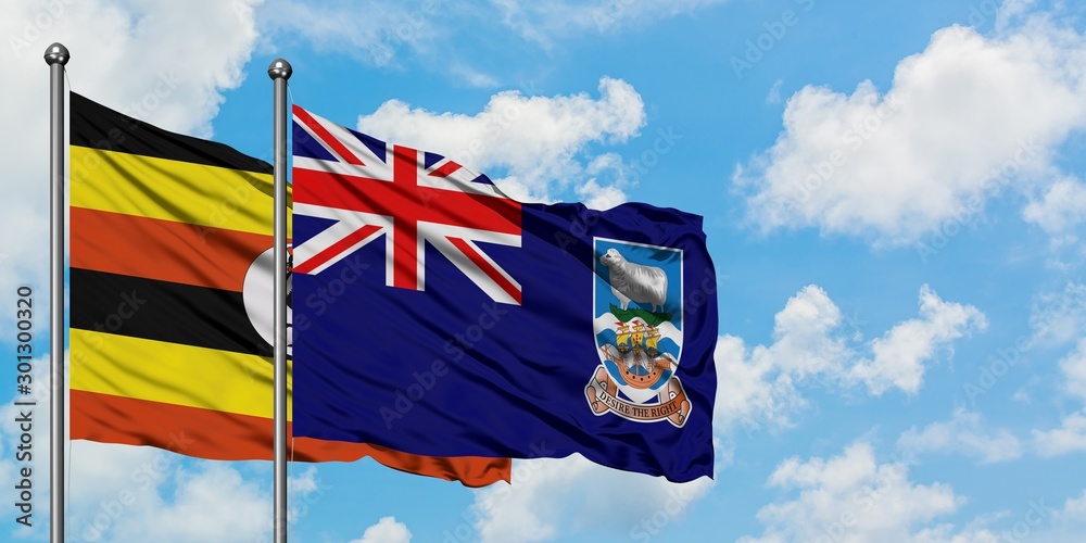 Uganda and Falkland Islands flag waving in the wind against white cloudy blue sky together. Diplomacy concept, international relations.