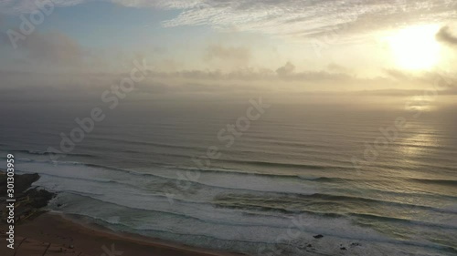 broad view of the Guincho Beach in Cascais, Portugal at the level of the clouds during sunset photo