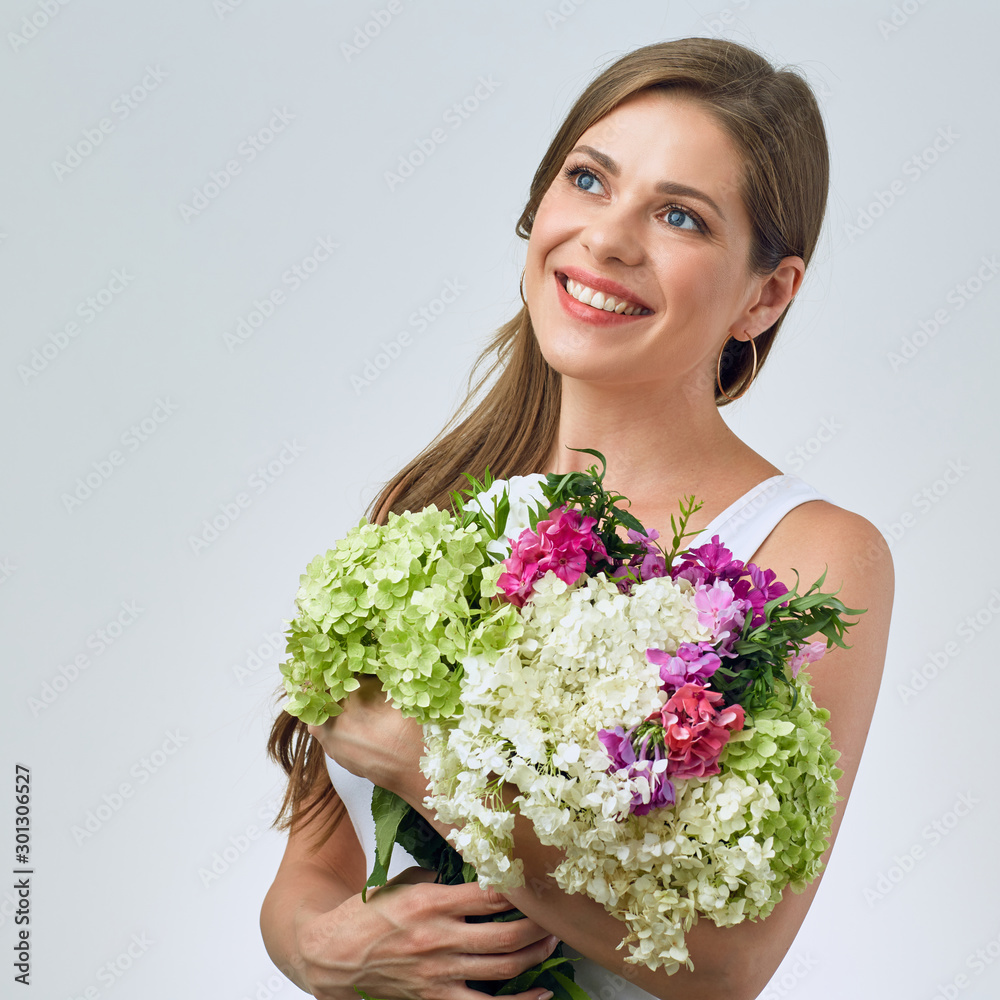 Happy woman holding flowers and looking at side. Happy woman holding flowers and looking at side.