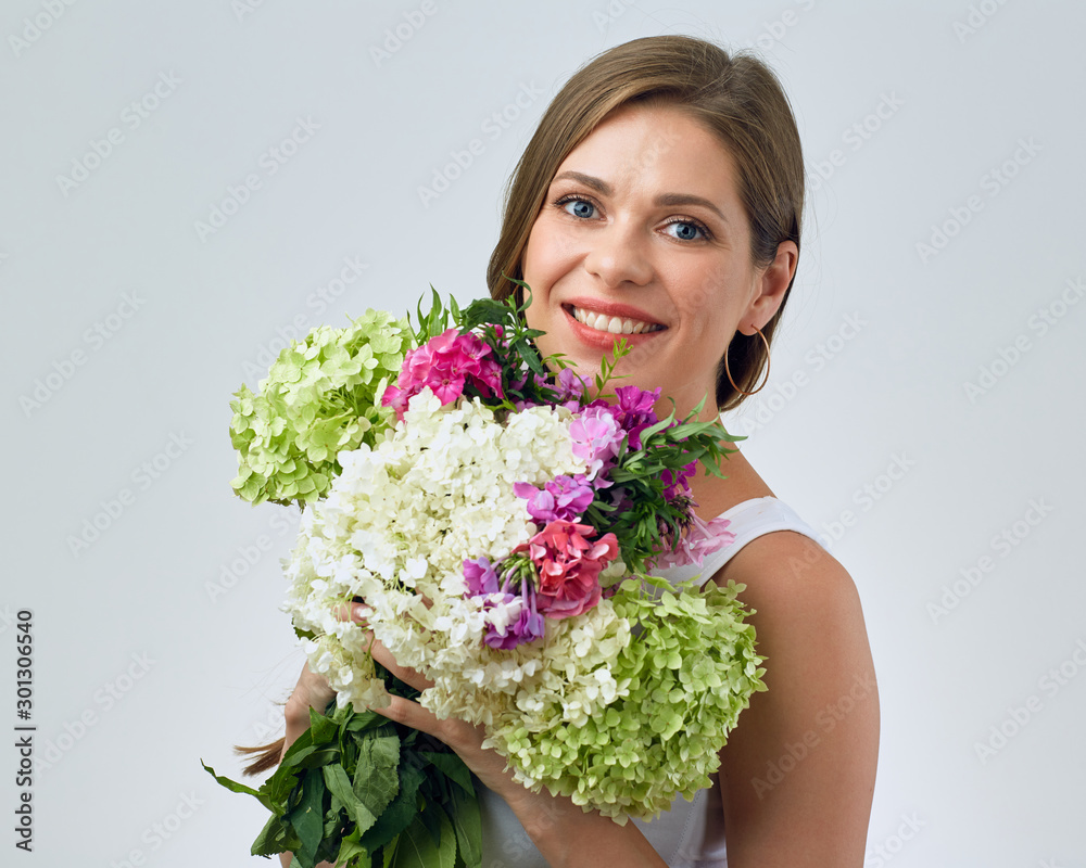 face portrait of smiling woman holding big flowers bouquet in front of face. face portrait of smiling woman holding big flowers bouquet in front of face.