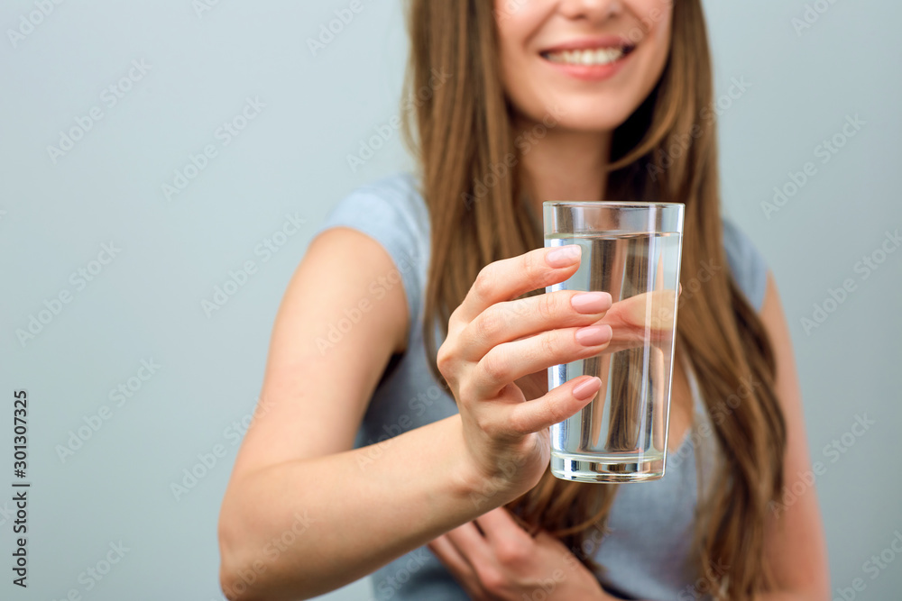 Half face portrait of smiling woman holding water glass. Half face portrait of smiling woman holding water glass.
