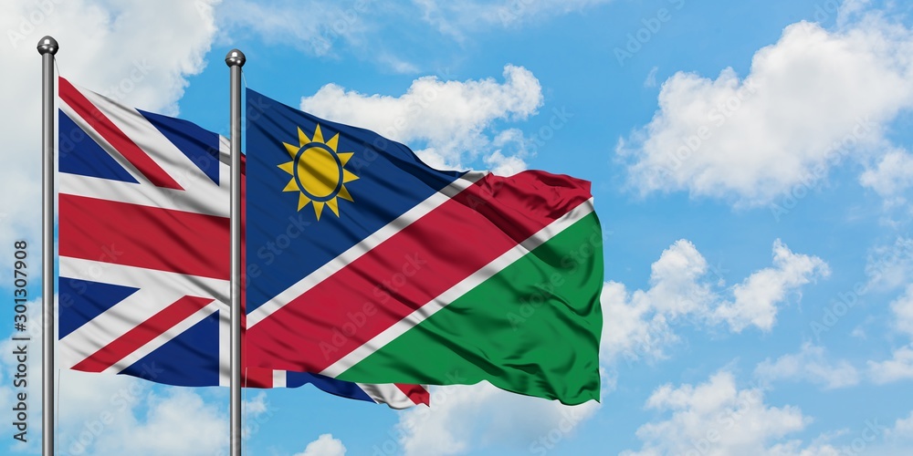 United Kingdom and Namibia flag waving in the wind against white cloudy blue sky together. Diplomacy concept, international relations.