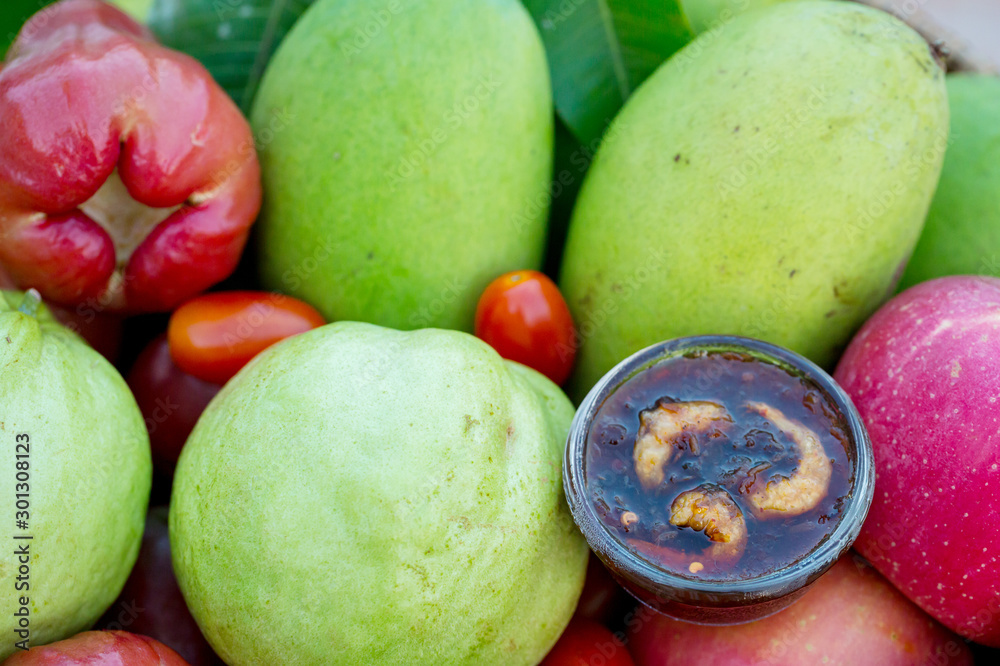 Raw mango slice with sweet dried shrimp sauce, Mango and Guava with sweet fish sauce is a delicious menu. Ancient thai food mango sweet fish sauce Street food in thailand