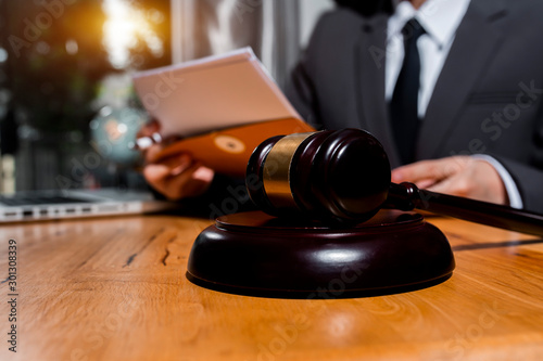 justice and law concept, Lawyer office. Statue of Justice with scales and lawyer working on a table.	 photo