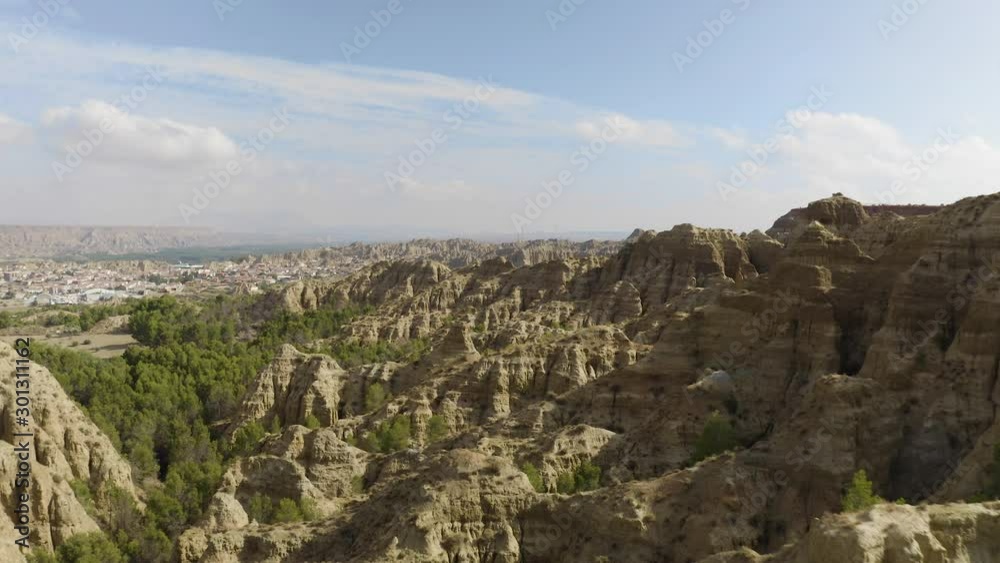 Aerial Drone shot of dry valley and mountains at Mirador del fin del mundo in Blue sky, Sierra Nevada, Granada, Spain. Spanish desert canyon with vegetation, in Andalusia. Drone flying low. 4K UHD. Aerial Drone shot of dry valley and mountains at Mirador del fin del mundo in Blue sky, Sierra Nevada, Granada, Spain. Spanish desert canyon with vegetation, in Andalusia. Drone flying low. 4K UHD.
