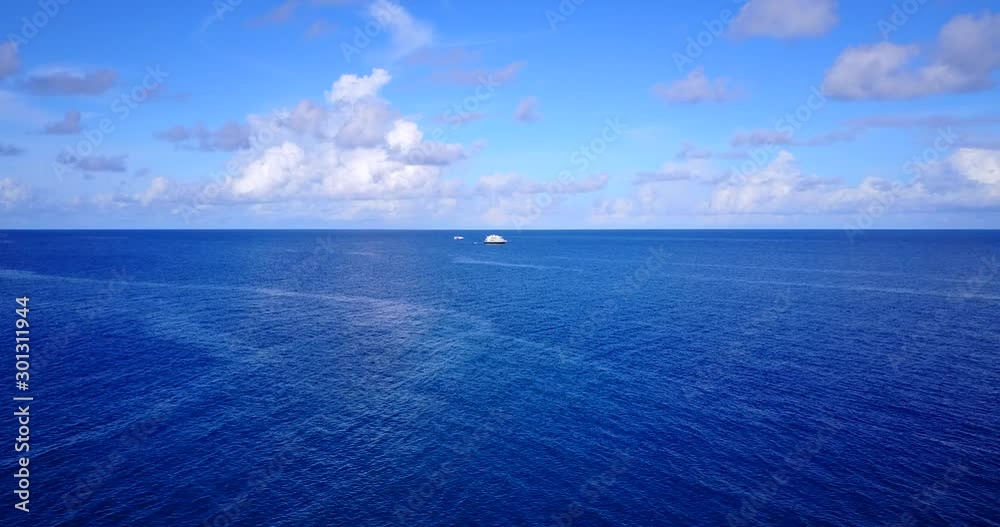 A Depth Blue Ocean Under the Cloudy Sky with Cruise Ship Floating in Barbados - Wide Shot A Depth Blue Ocean Under the Cloudy Sky with Cruise Ship Floating in Barbados - Wide Shot