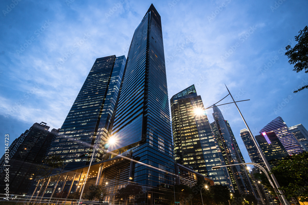 Dramatic view of modern skyscrapers in the Singapore business district at nightfall in Singapore, Southeast Asia Dramatic view of modern skyscrapers in the Singapore business district at nightfall in Singapore, Southeast Asia