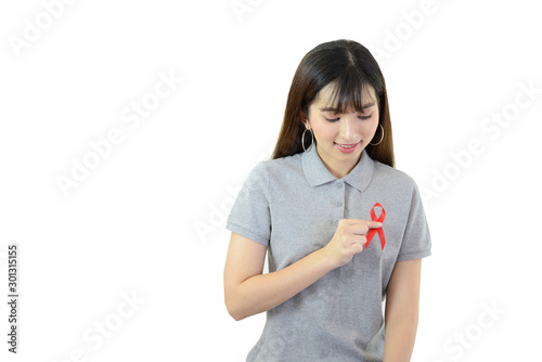 woman is holding red ribbon (Aids Symbol) on white isolated background © Chanida
