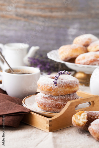 Homemade ring donuts on a rustic wooden background.  donuts with coffee candies on wooden background. Party food concept. 
