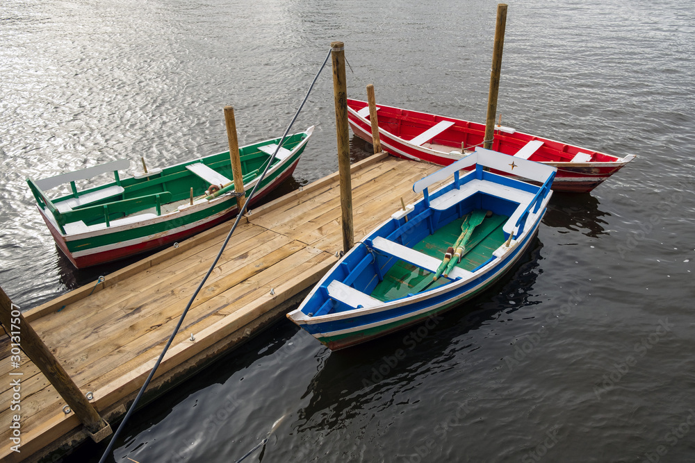 three rowing boats on a jetty