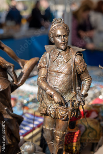 Trinket and close-up bronze figurine on antique flea market in Barcelona Spain