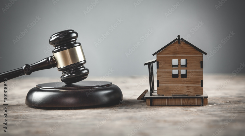 House model with a judge gavel. House model with a judge gavel.