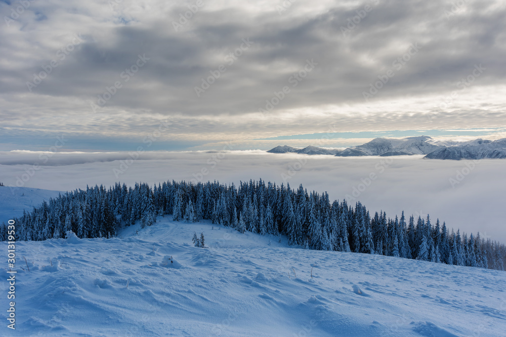 Beautiful scenery with winter snow-capped mountains, with fogs and contrasting snow structure and red tourist tent in the foreground, in locations in the Ukrainian Carpathians. Beautiful scenery with winter snow-capped mountains, with fogs and contrasting snow structure and red tourist tent in the foreground, in locations in the Ukrainian Carpathians.