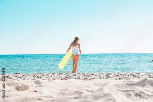 Girl goes swimming on the beach with a rubber ring