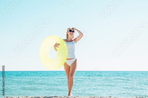 Girl goes swimming on the beach with a rubber ring
