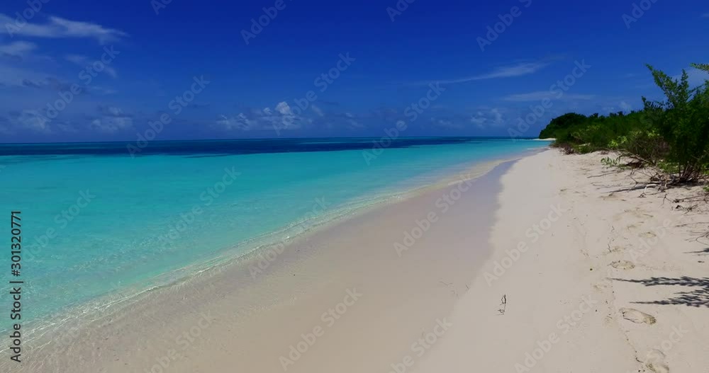 Untouched white sand washed by calm turquoise lagoon, deep blue ocean horizon line under bright sky in Turks and Caicos islands Untouched white sand washed by calm turquoise lagoon, deep blue ocean horizon line under bright sky in Turks and Caicos islands