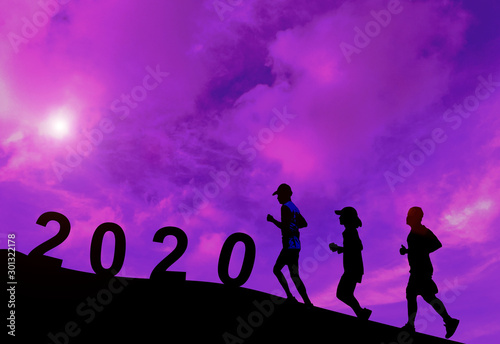  Silhouette man and womne running exercise.Concept new year's eve welcome new year celebration 2020 in the evening atmosphere Sunset. © Thipsuda