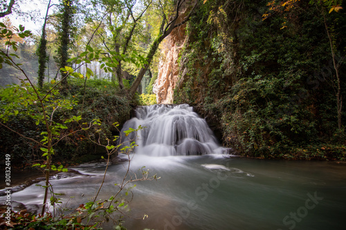 river with waterfall in the autumn season