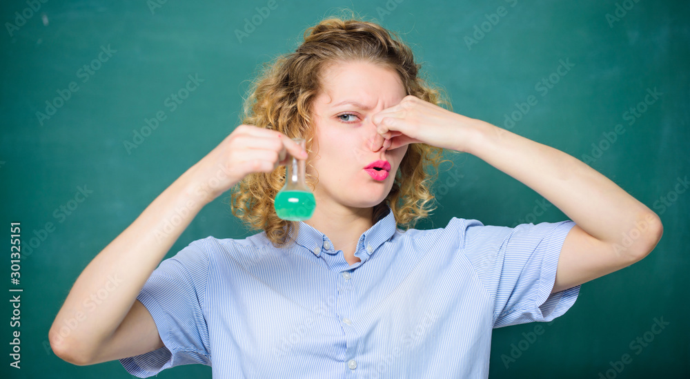 stench. girl hold chemical flask with liquid. student with beaker. scientist at school lab. school lesson. biology experiment. sample formula. chemistry research results