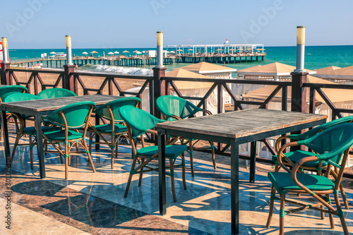 Empty table and chairs in restaurant on the beach  Turkey. Beach cafe near sea  outdoors. Travel and vacation concept