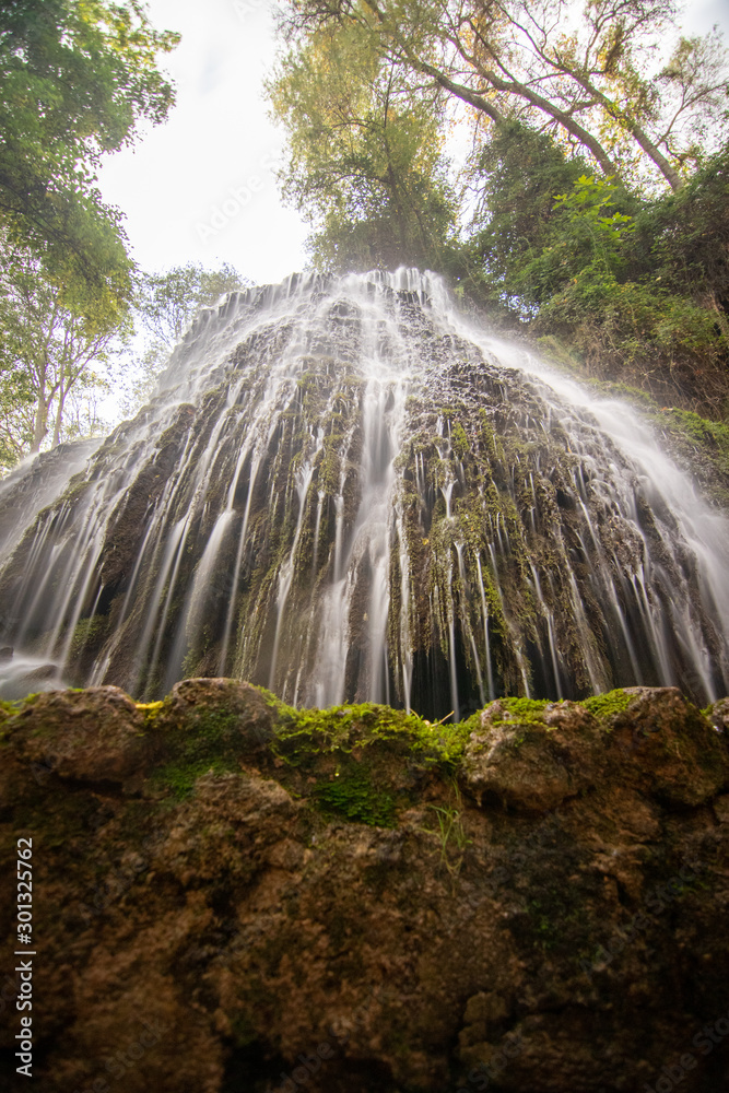 Obraz premium river with waterfall in the autumn season