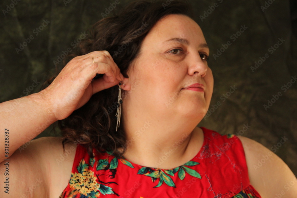 fat woman in a red dress dresses earrings. Model size plus fat woman in a red dress dresses earrings. Model size plus