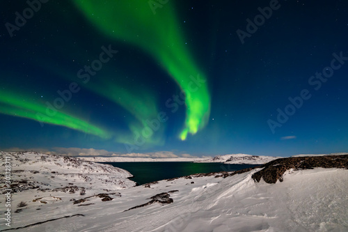 Northern Lights on the shore of the Arctic Ocean.
