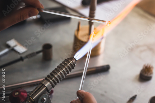 Lampworker workshop. Glassblowing hand tools. Lampworker workshop. Glass on fire. Master at work with fires.