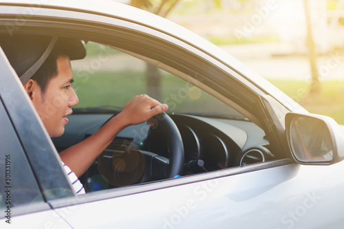 young man driving  car along the road © PONGNARET