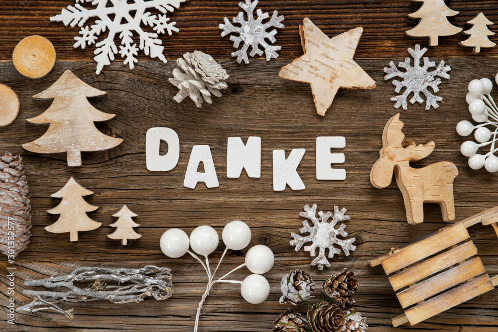 Letters Building The Word Danke Means Thank You. Wooden Christmas Decoration Like Tree, Sled And Star. Brown Wooden Background