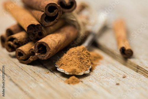 Cinnamon Sticks - A closeup of cinnamon sticks with ground cinnamon.