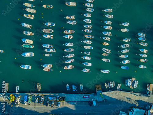Aerial view of many boats and yachts anchored in water. Harbor in open water in Europe.