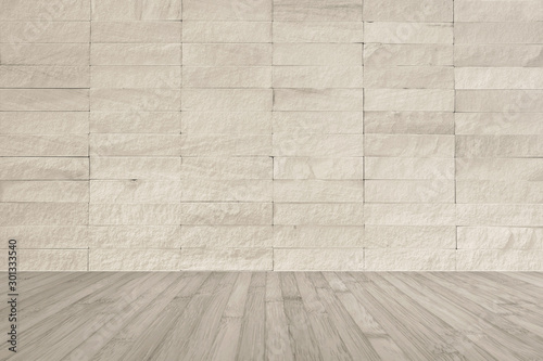 Cream beige rock tile wall with wooden floor in light sepia brown color for interior background...