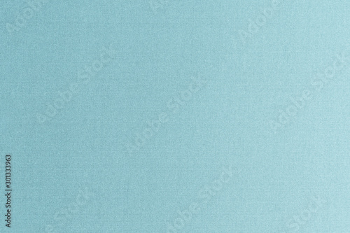 Authentic fine Thai silk fabric textile detailed background in light pale blue green teal color tone