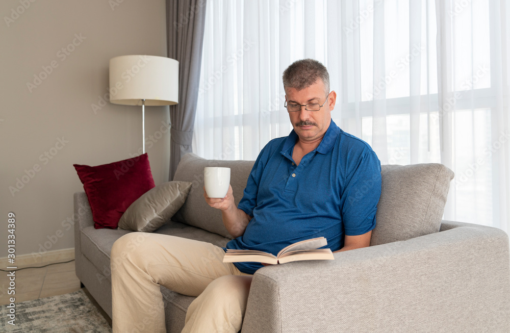 middle aged man reading a book middle aged man reading a book