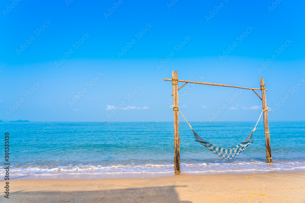 Empty hammock swing on the beautiful beach and sea Empty hammock swing on the beautiful beach and sea