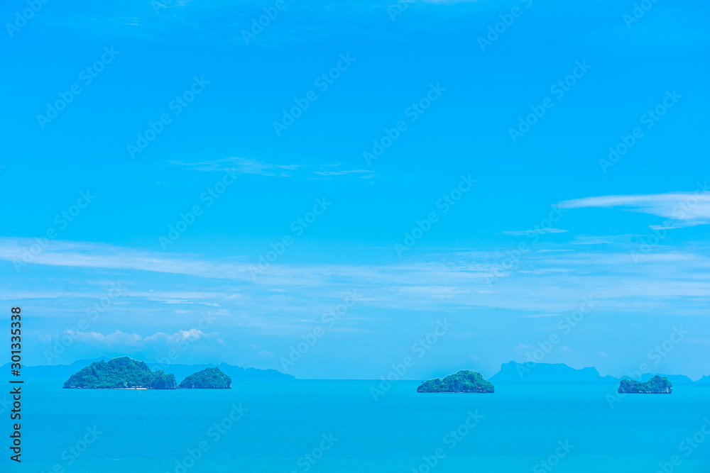 Beautiful outdoor sea ocean view with island and white cloud on blue sky