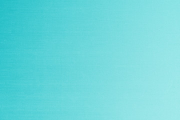 Blue silk fabric wallpaper texture detail background in shiny cyan green turquoise color
