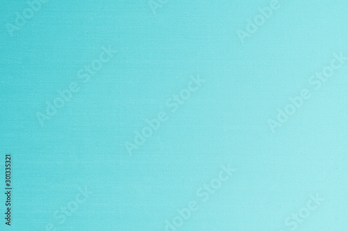 Blue silk fabric wallpaper texture detail background in shiny cyan green turquoise color