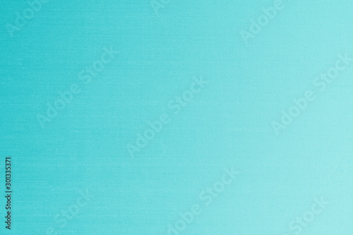 Blue silk fabric wallpaper texture detail background in shiny cyan green turquoise color